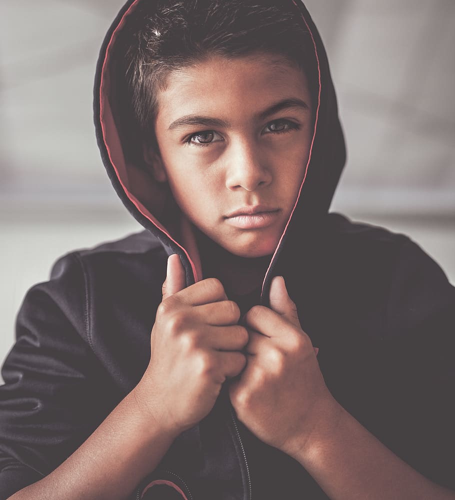 boy in black hoodie, portrait, front view, one person, looking at camera
