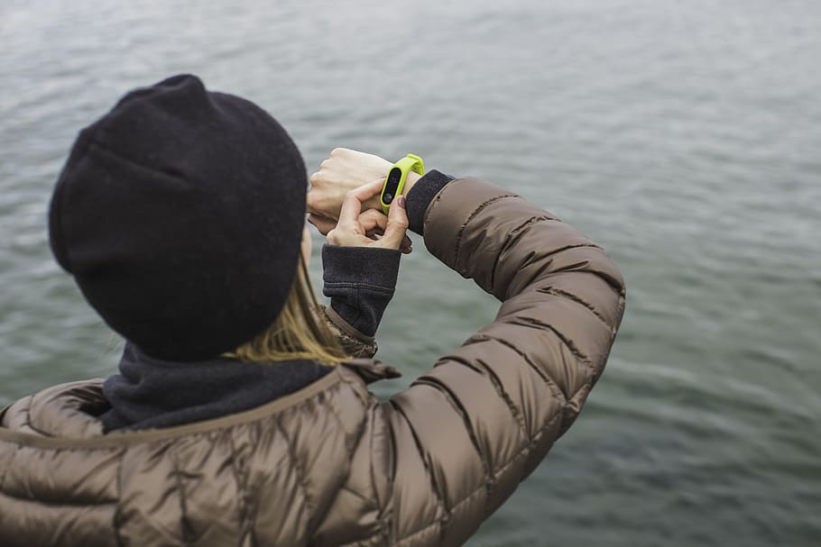 Woman Looking at Black and Yellow Activity Tracker, bonnet, daylight HD wallpaper