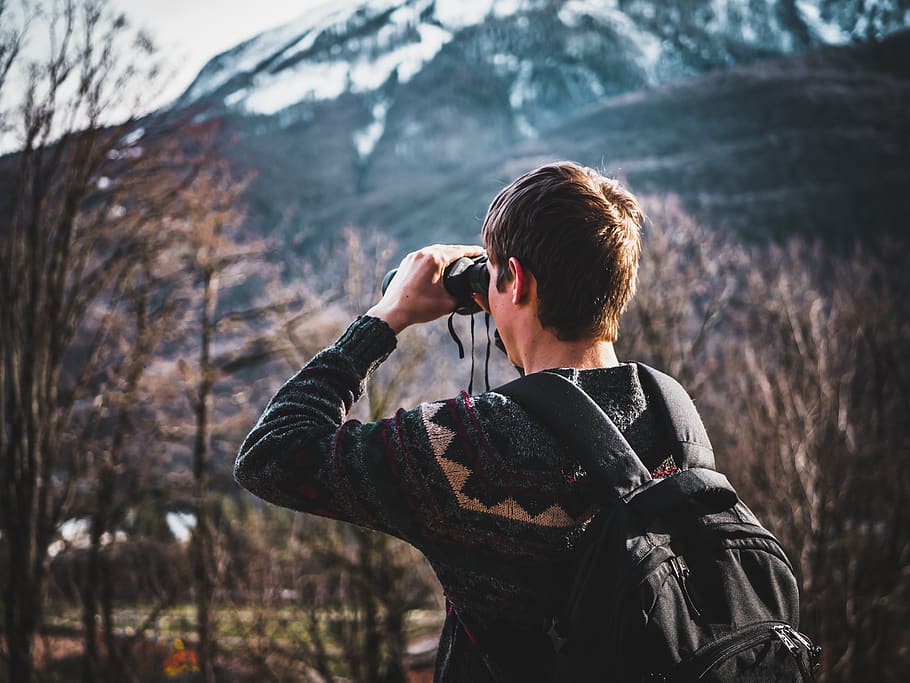 Man Using Black Binoculars Near Forest Trees at Daytime, background HD wallpaper