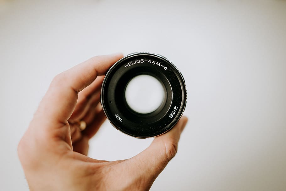 black DSLR camera lens, person, human, electronics, finger, alloy wheel