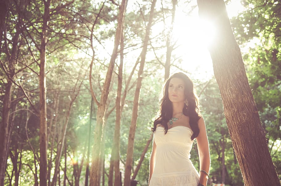 woman wearing white dress standing beside tree, apparel, clothing