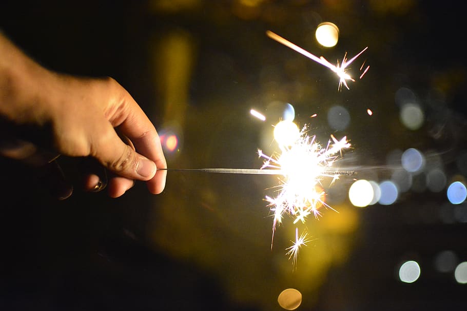 fire, firework, bokeh, sparkler, human body part, burning, human hand HD wallpaper