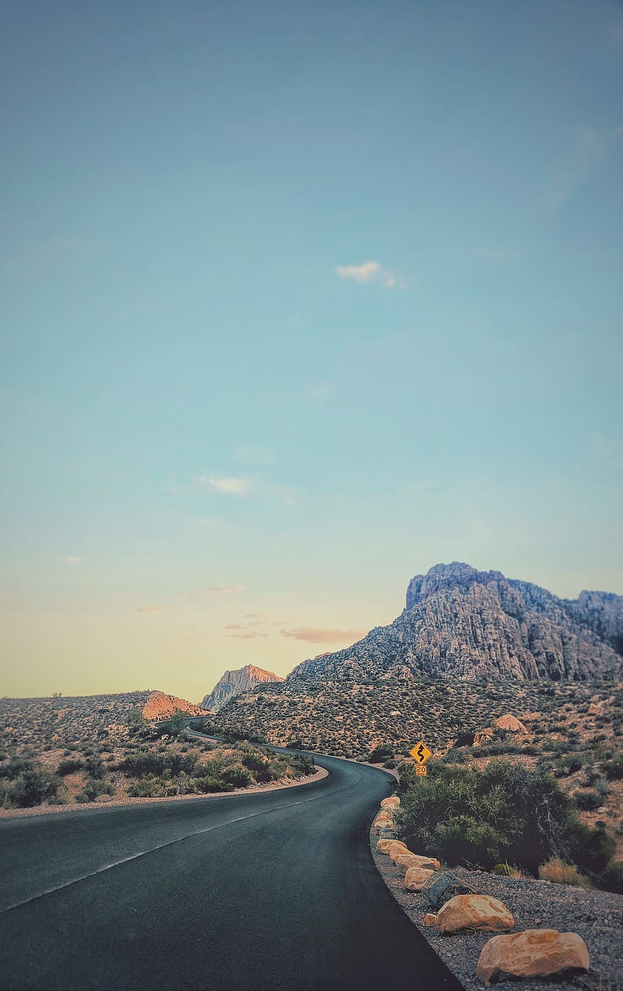 road through mountain, sunset, sunrise, bend, perspective, sign HD wallpaper