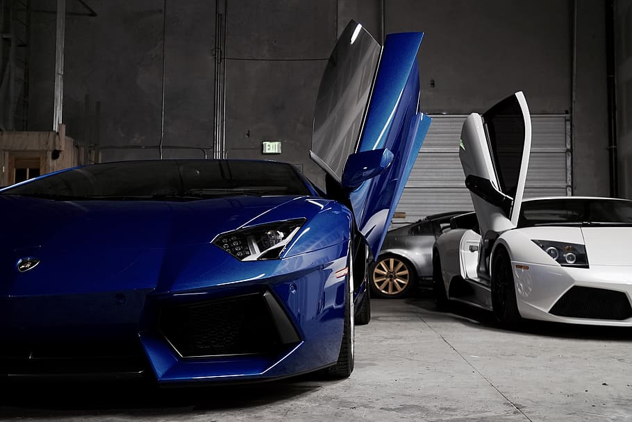 HD wallpaper: two white and blue Lamborghini vehicles inside garage