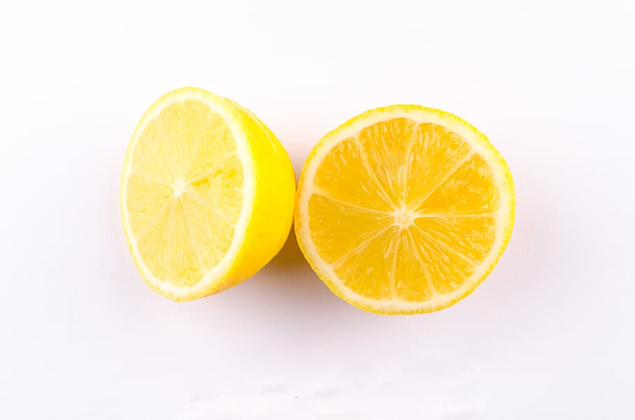 Close-up Photo of Sliced Yellow Lemon on White Surface, bright HD wallpaper
