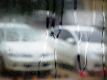 Abstract of white cars through a steamed up window with water droplets HD wallpaper