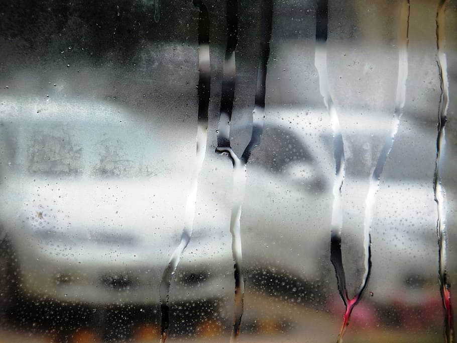 Abstract of white cars through a steamed up window with water droplets HD wallpaper