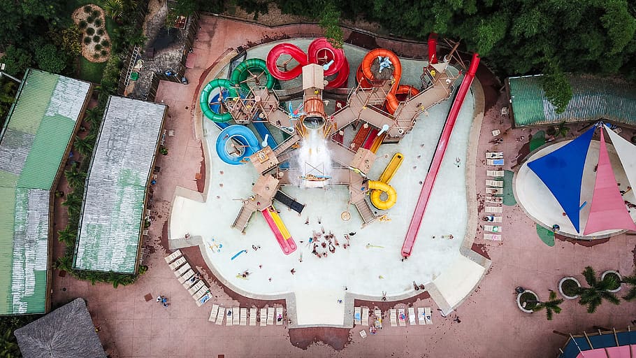 aerial photo of swimming pool with slides, tent, amusement park