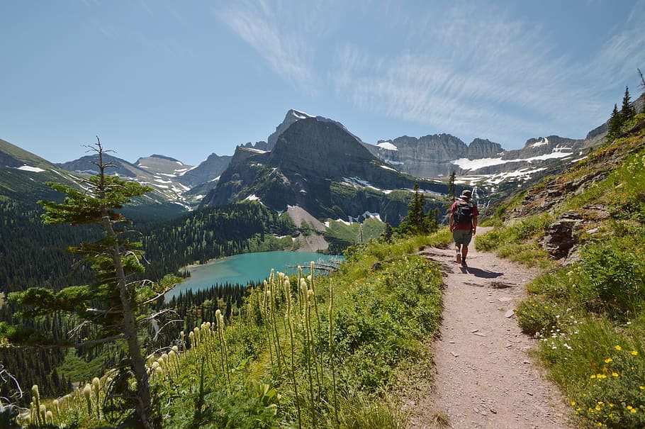 Man Walking on Road While on Mountain, backpack, clouds, daylight HD wallpaper