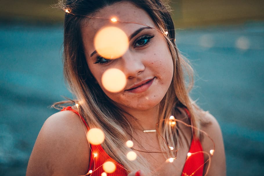 shallow focus photo of woman in red spaghetti strap top, person