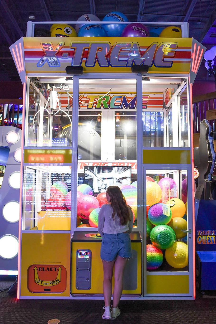 Woman Standing in Front of X-treme Arcade Machine, arcade game