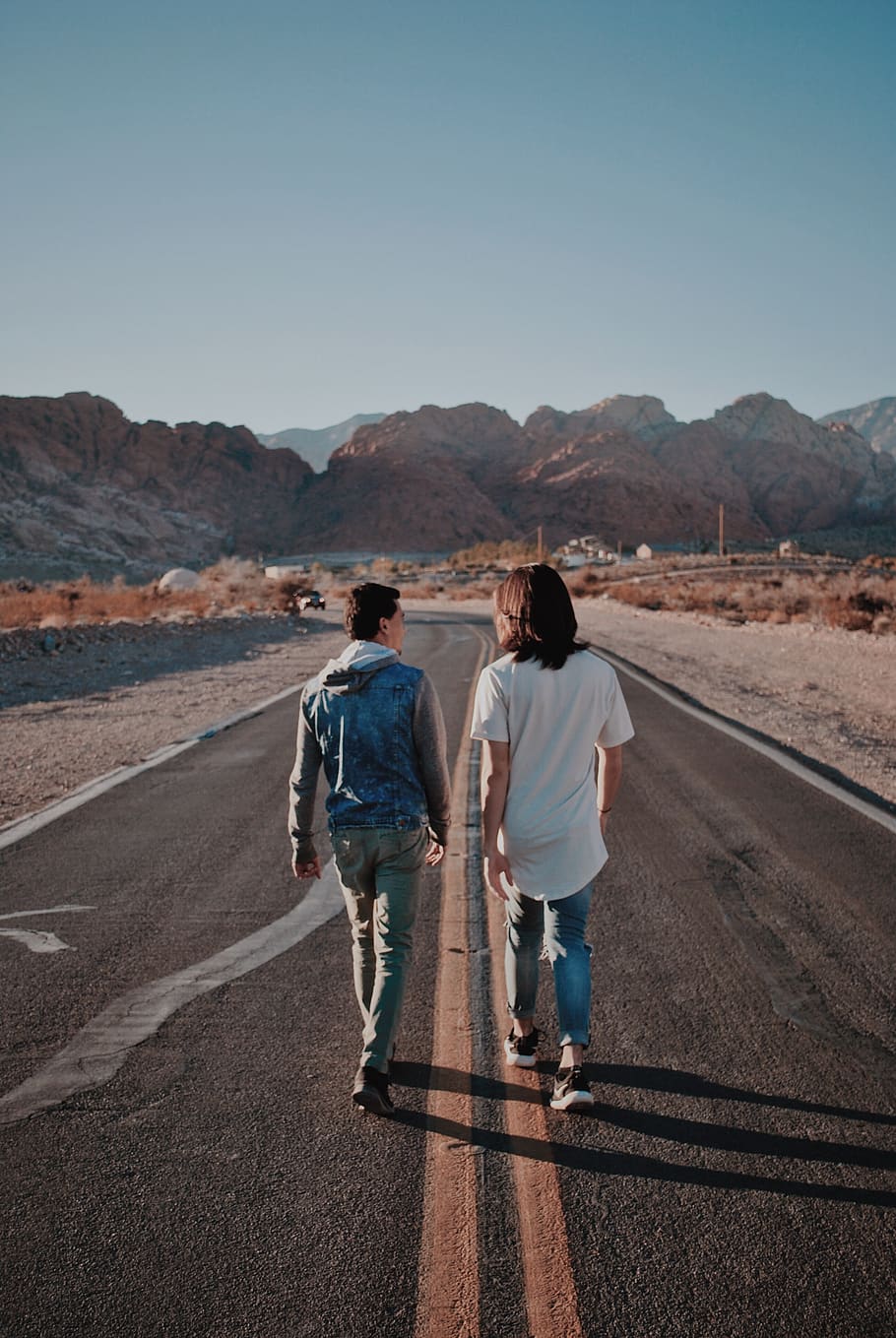 two men walking on road, two people, rear view, mountain, transportation HD wallpaper