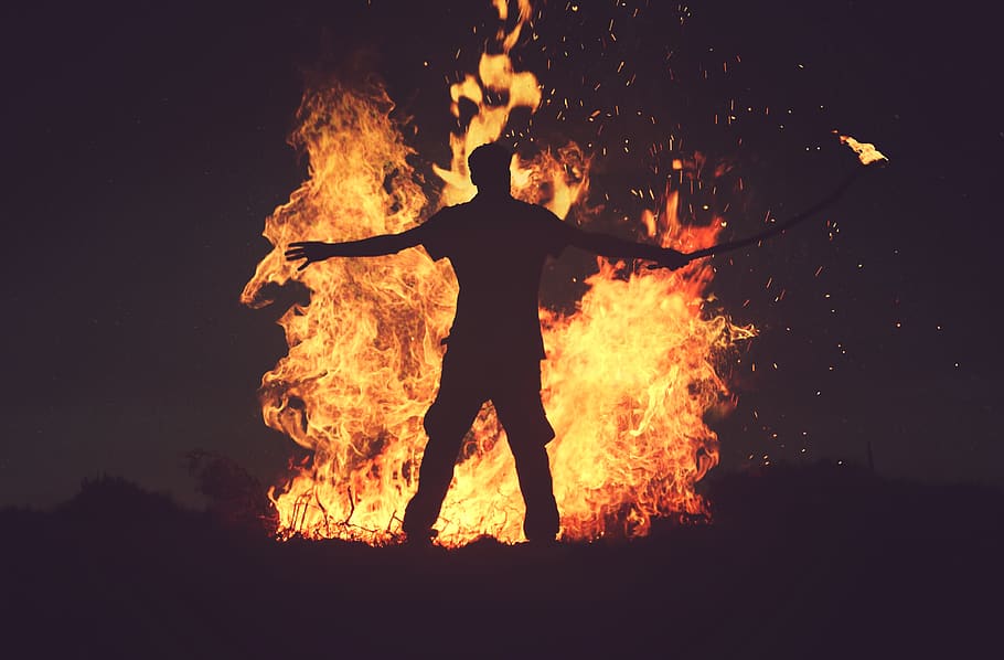 fire, flame, bonfire, dark, night, heat, firewood, light, people HD wallpaper