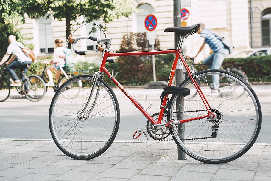 Red Bike Parked Beside Post, bicycle, pavement, road, steel, street HD wallpaper