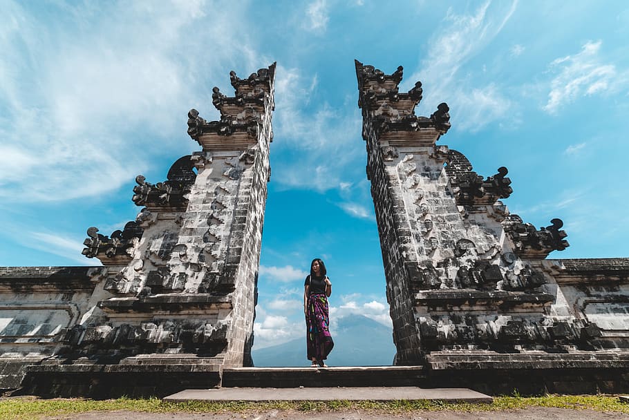 woman standing between concrete structures under blue sky, human HD wallpaper