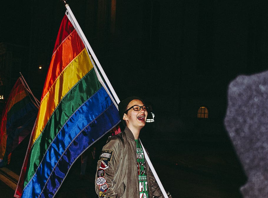 Person Laughing Beside Flag, colorful, eyeglasses, jacket, lgbt, HD wallpaper