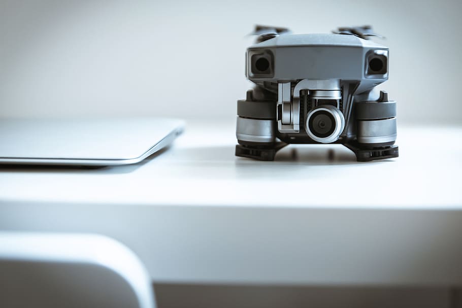 Modern drone with camera on white table at the office, technology HD wallpaper