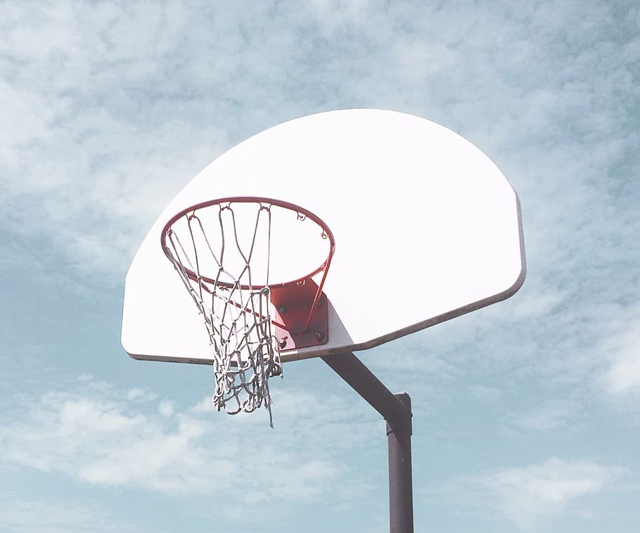 low-angle photography of basketball ring under cloudy sky, hoop