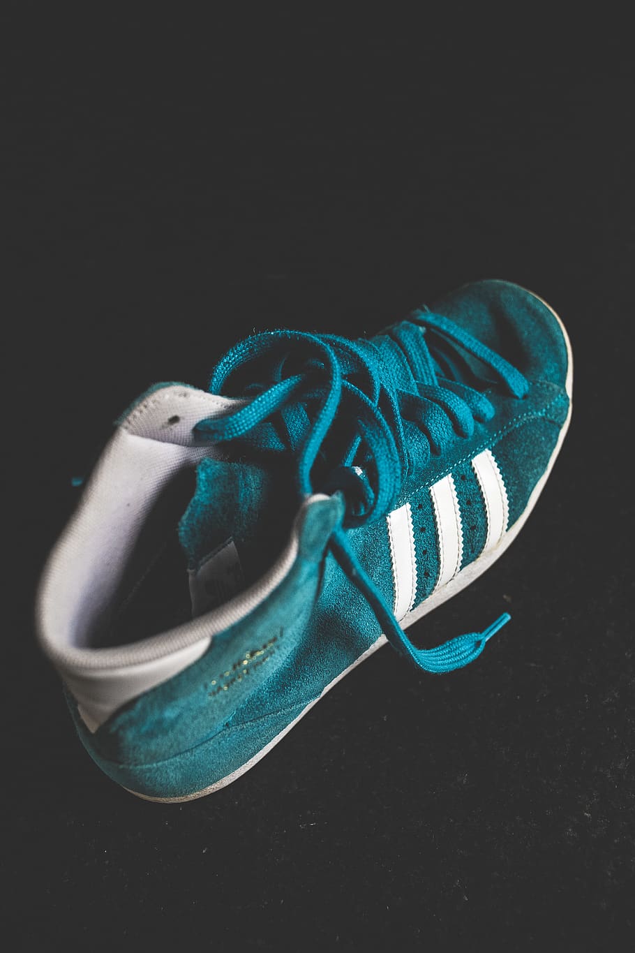 Close-up Photo of a Suede Turquoise and White Adidas High-top Sneaker