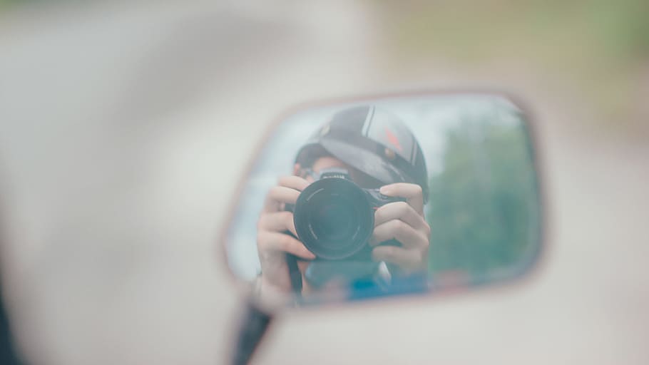 Shallow Focus Photography of Person Holding Dslr Camera in Mirror Reflection HD wallpaper