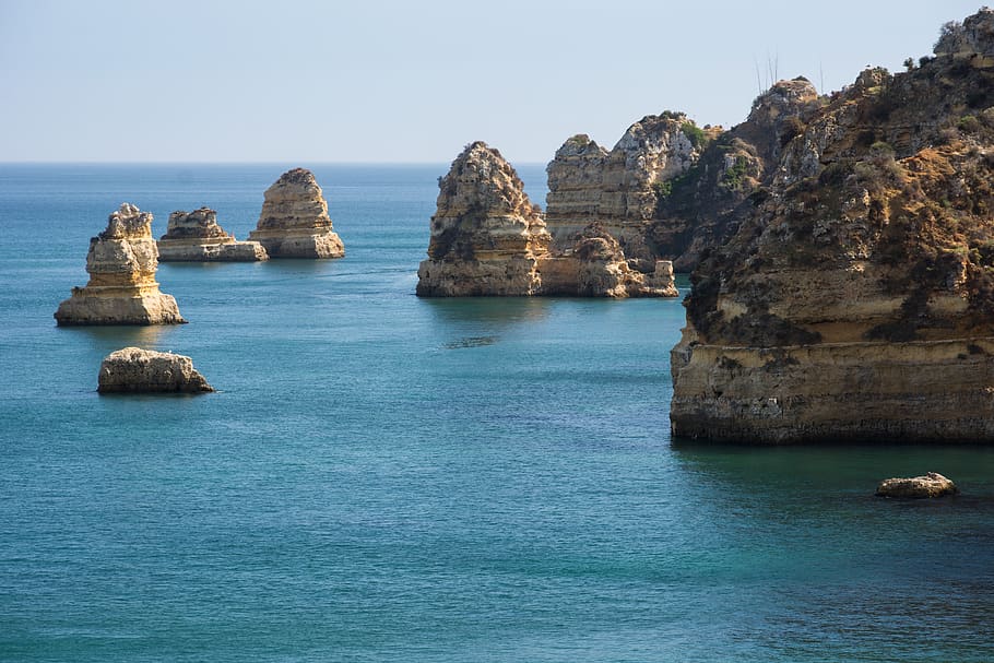 Brown Rock Formation Under White Sky, cliff coast, sea, water HD wallpaper
