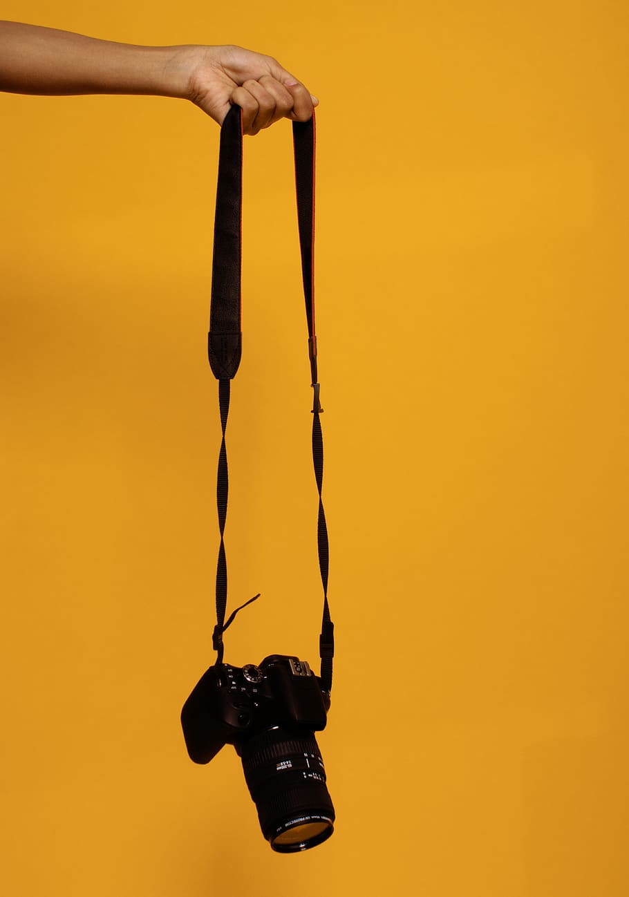 Photo of Person Holding Black Dslr Camera, camera lens, camera strap HD wallpaper