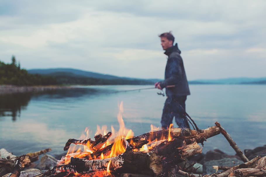 bonfire, flames, camping, lumber, logs, young, guy, man, fishing rod HD wallpaper