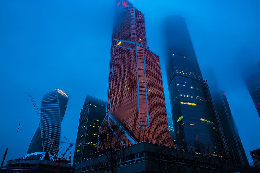 Low Angle Photography of High Rise Buildings Covered With Fogs