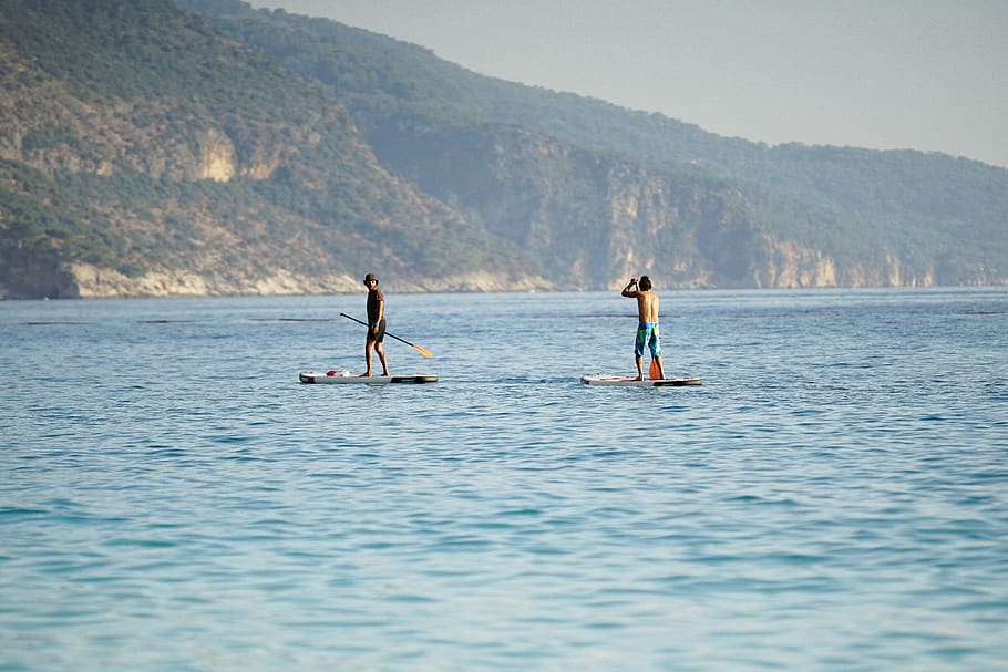 two men boat paddling on body of water, ölüdeniz, turkey, leisure activities