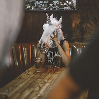 Person With Unicorn Head Sitting Near Table, blur, close-up, design HD wallpaper