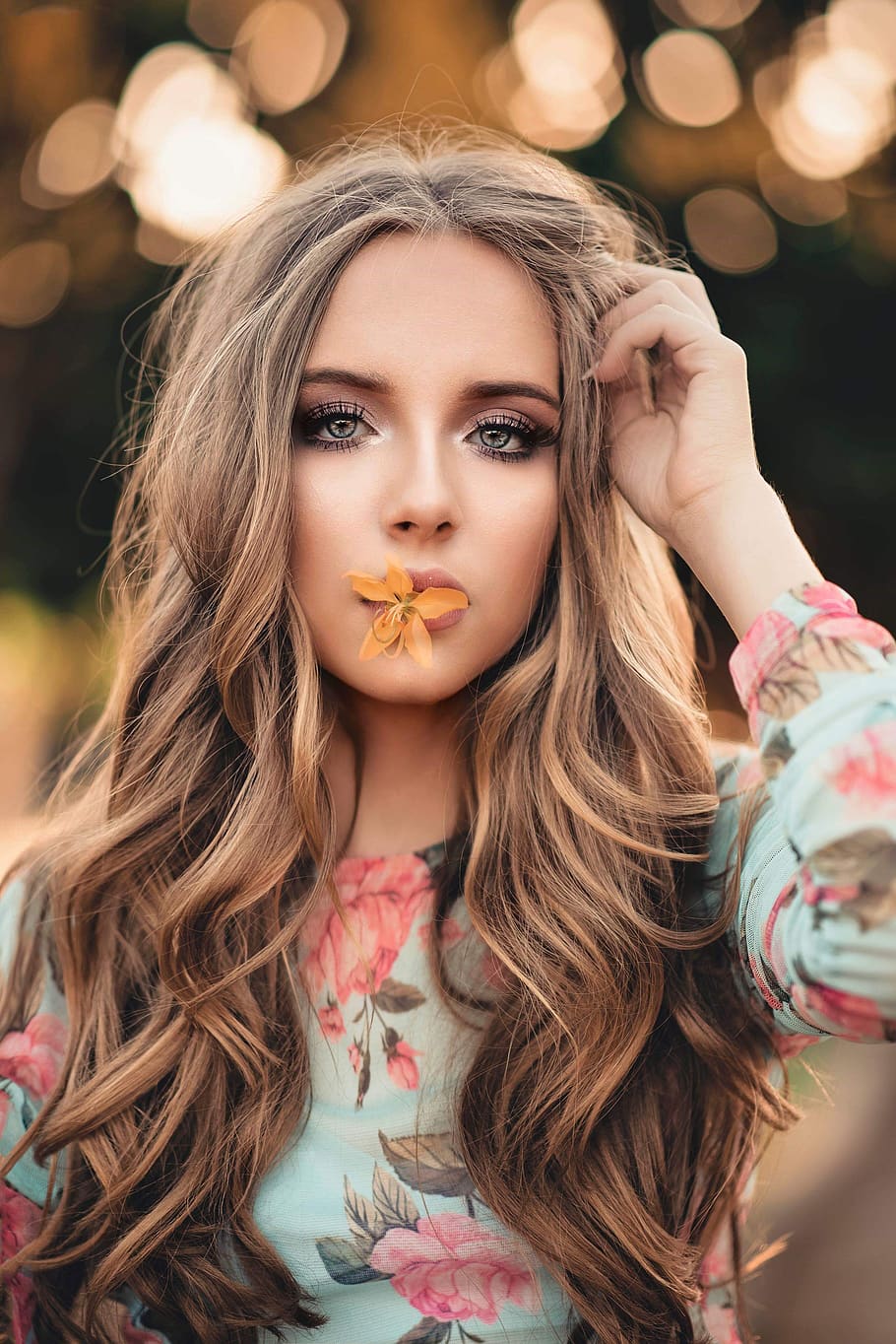 Woman With Orange Petaled Flower on Her Lips, attractive, beautiful
