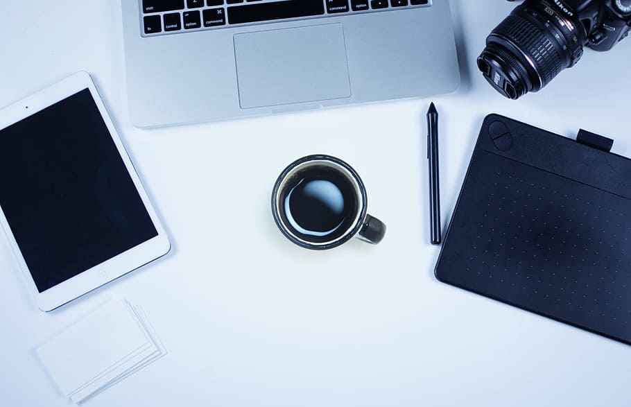 Sparse work area with camera, coffee, computer and Ipad., cup HD wallpaper