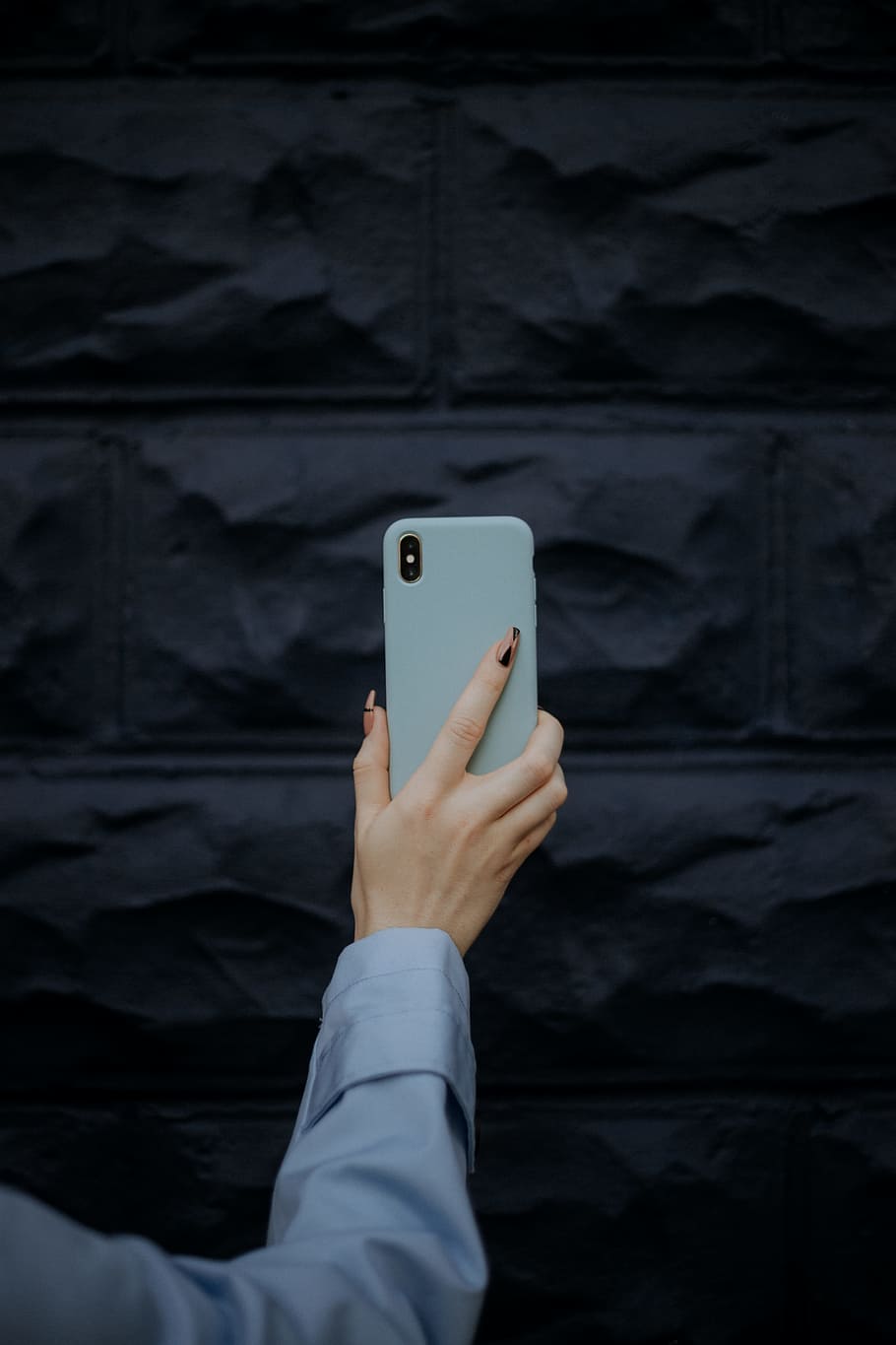 person holding iPhone X, phone case, hand, smartphone, camera