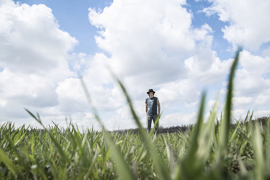Photo of Person Standing On Grass Field, cloudiness, clouds, cloudy HD wallpaper
