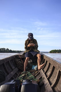 Man Wearing Black Cap Sitting Inside a Boat, background, cellphone HD wallpaper