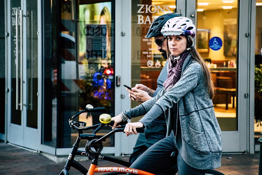 Woman Riding on Bicycle, bicycles, daylight, helmets, pavement HD wallpaper