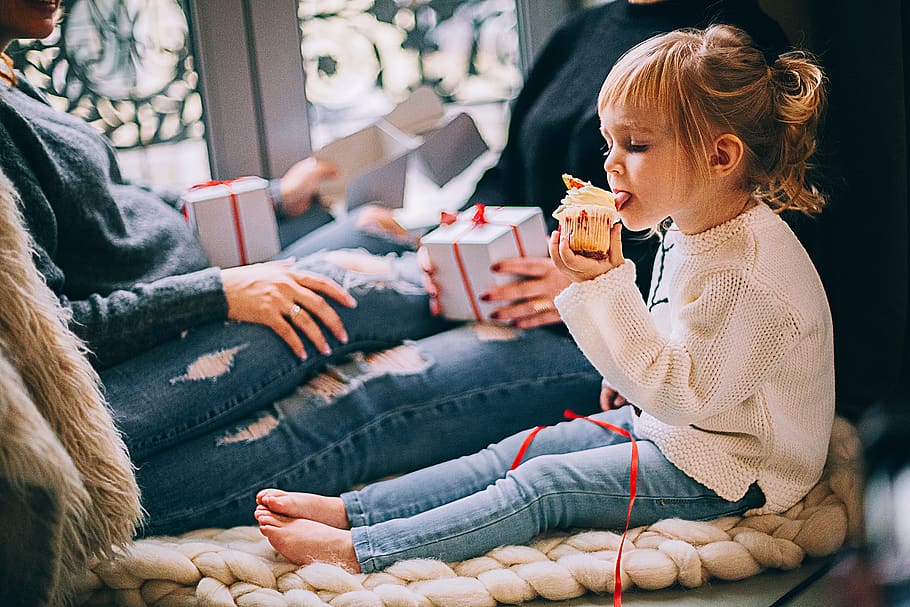 Girl Eating Cupcake While Sitting Beside Woman in Blue Denim Distressed Jeans, HD wallpaper