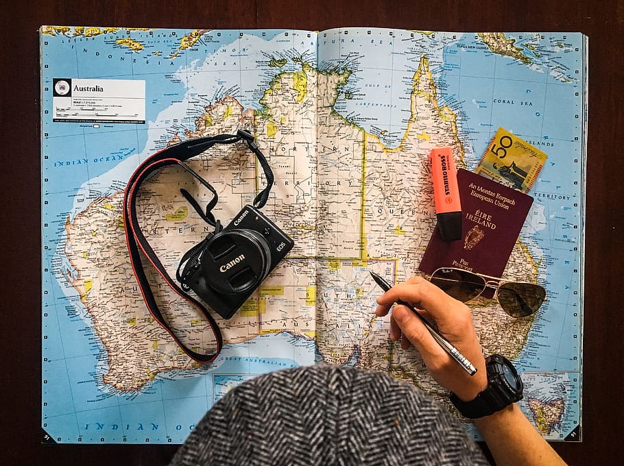 Persona planeando su viaje a Australia sobre un mapa