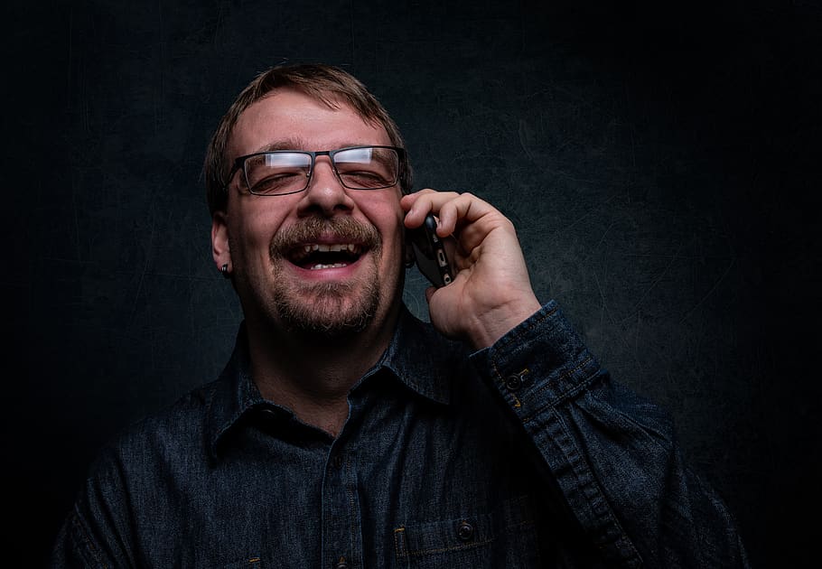 Man Laughing While Using Cellphone, device, electronics, eyeglasses HD wallpaper