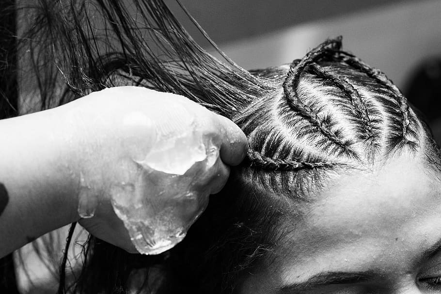 A gray scale photo of a woman's hair being plaited, adult, art