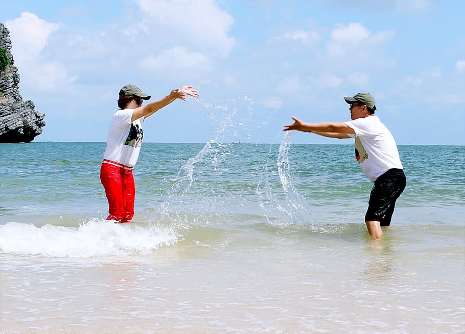 Man And Woman Splashing Water To Each Other, beach, enjoyment HD wallpaper