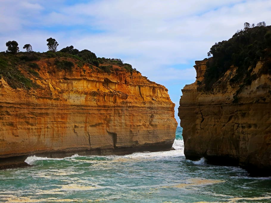 two brown cliffs, sea, outdoors, ocean, rock, canyon, vacation HD wallpaper