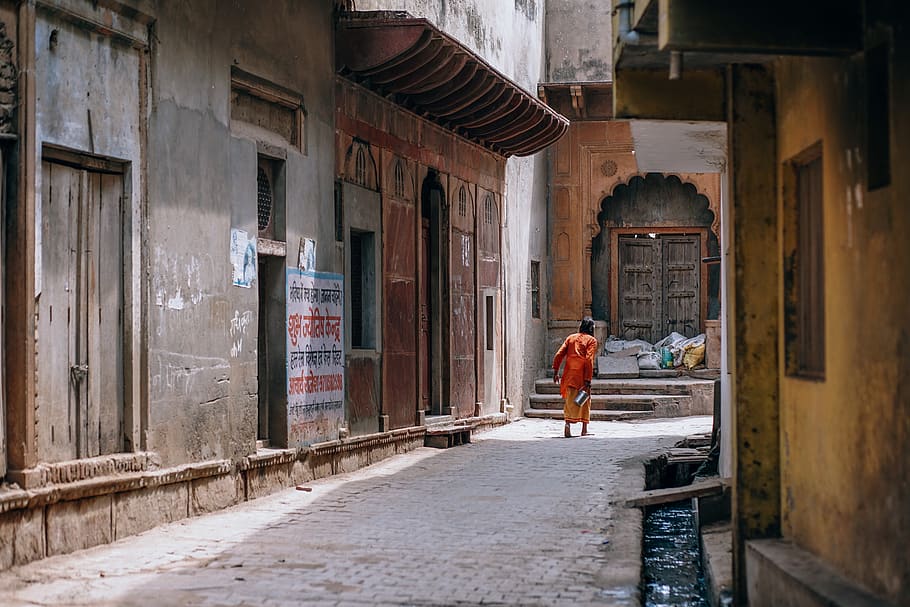 person walking on street during day time, urban, alley, vrindavan