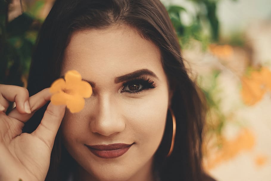 Woman Holding Yellow Petaled Flowers Covering Her Right Eye, attractive