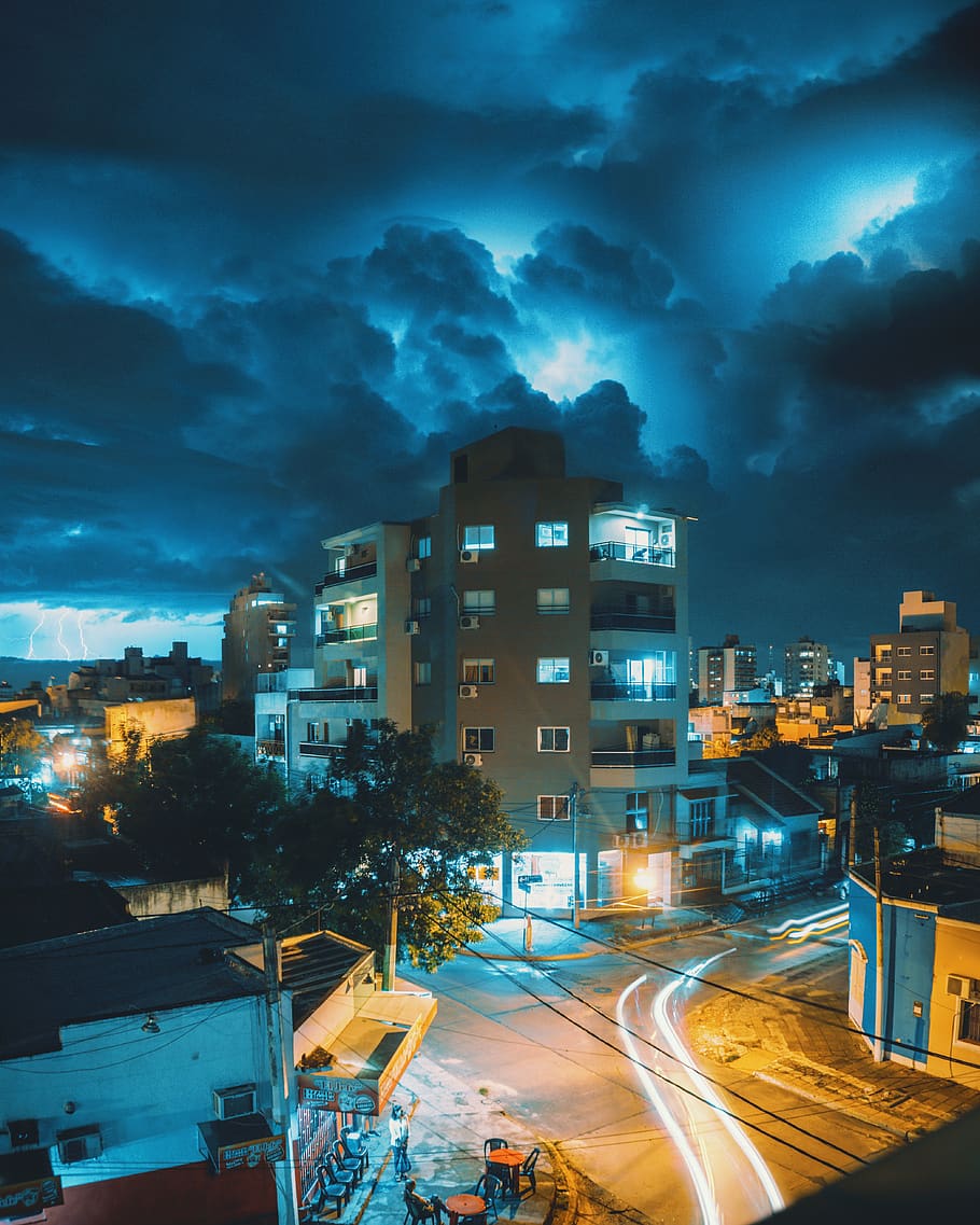 beige concrete building under dark clouds, road, city, nature HD wallpaper
