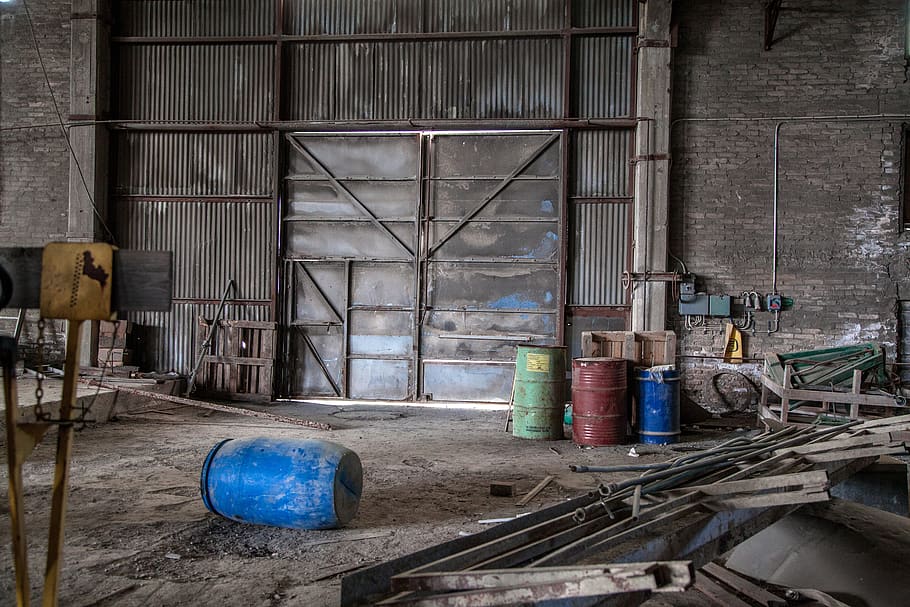 Blue Plastic Barrel on Floor Surrounded by Metal Pipe Inside Warehouse HD wallpaper