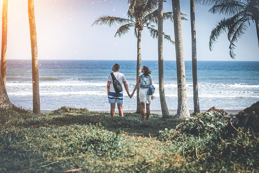 Man and Woman Holding Hand Near Beach Shore Under Sunny Sky, blue HD wallpaper