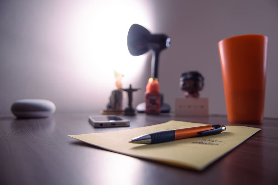 Retractable Pen on Perer Near, Plastic Cup, Smartphone, and Lamp on Desk HD wallpaper