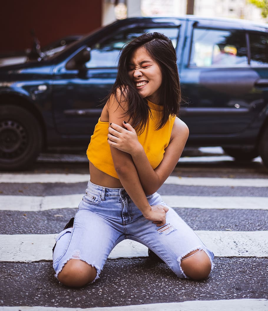 Smiling Woman Kneels on Pedestrian Lane, asphalt, attractive HD wallpaper