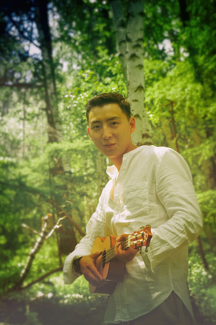 man wearing white dress shirt holding brown ukulele, human, person